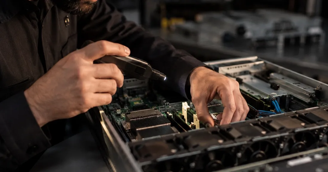 Technician performing hardware diagnostics on an open enterprise server