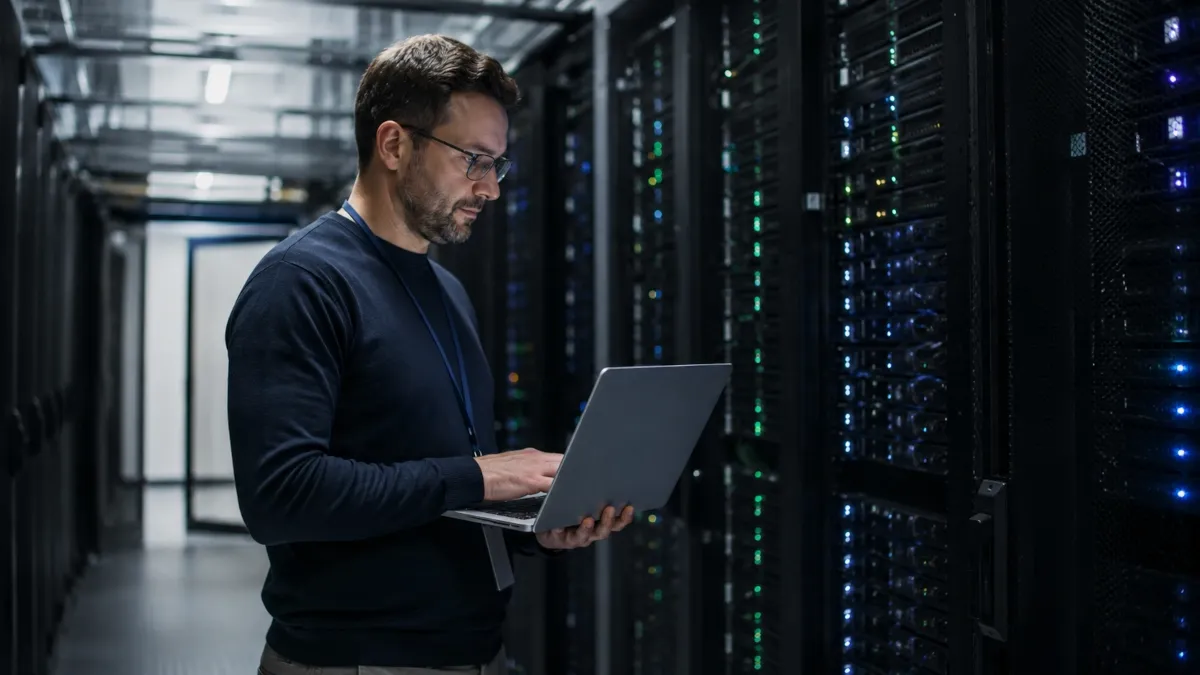 IT infrastructure manager reviewing server health and support contract data in a data center